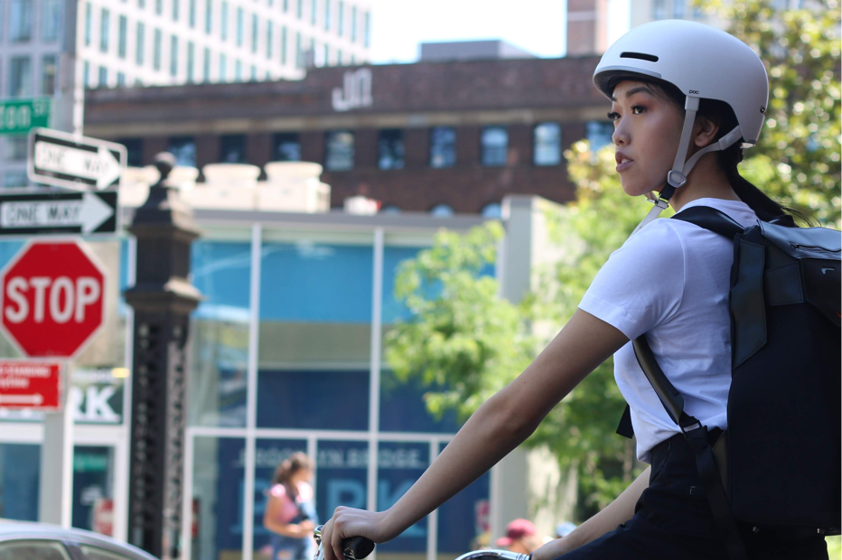 A photo of a young woman riding a bike.